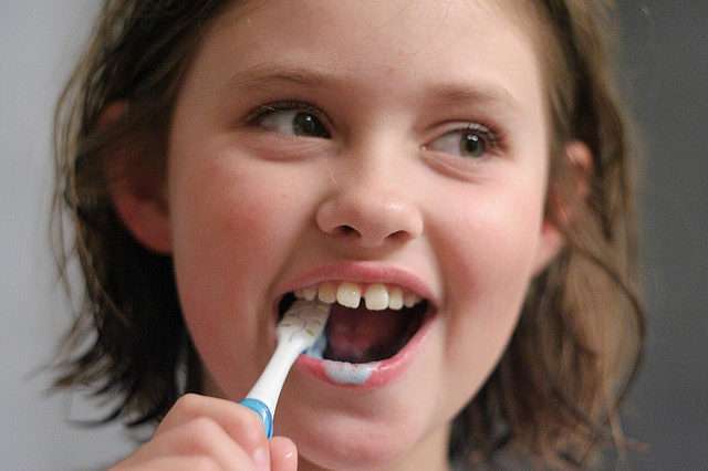 Little Girl Brushing Her Teeth