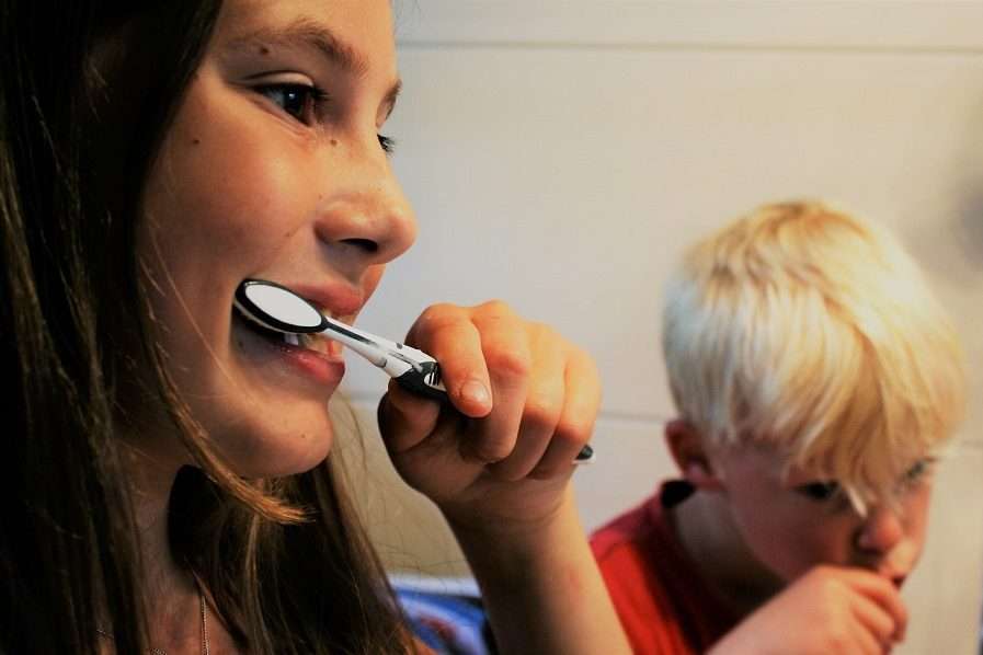 Girl and Boy are Brushing Their Teeth