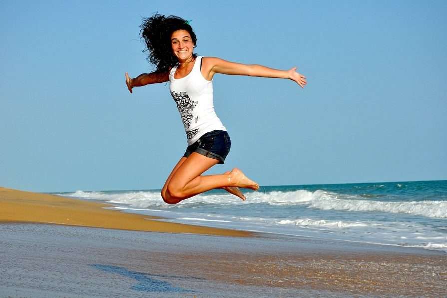 Girl is Jumping Up on the Beach