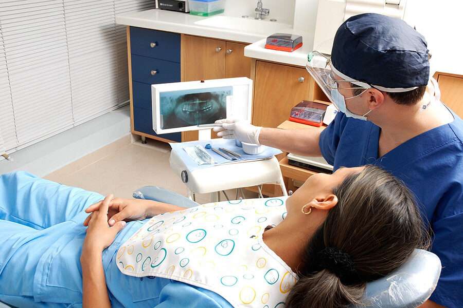 Doctor with Patient in Dental Room