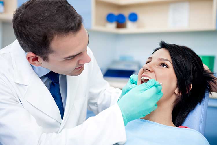Doctor with Patient in Dental Room