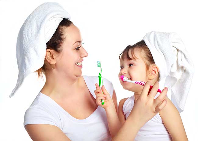 Mother and Daughter are Brushing Their Teeth