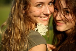 Two Happy Girls with White Flower