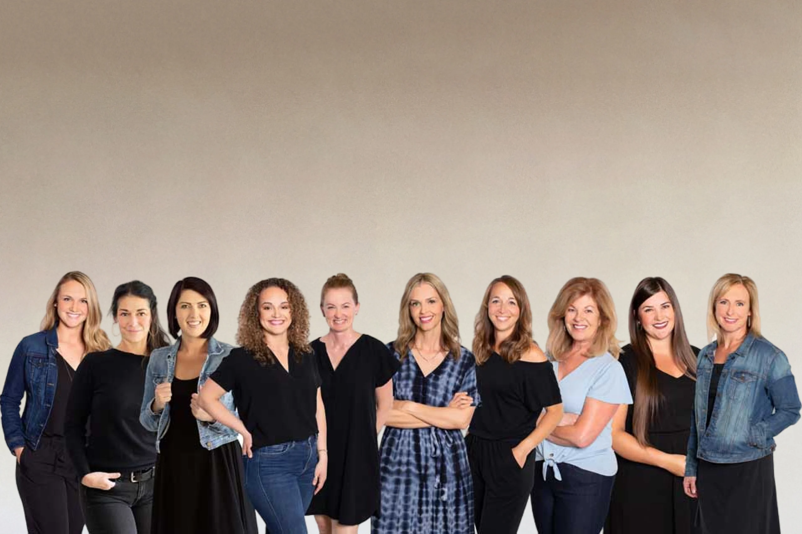 Summit Dental Group team of eleven diverse professionals standing together against neutral background, smiling at camera.